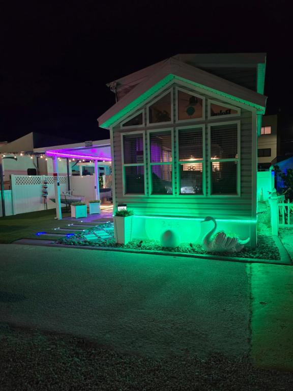 a house with green lights on the side of the street at Marina View Cottage at Key Largo in Key Largo