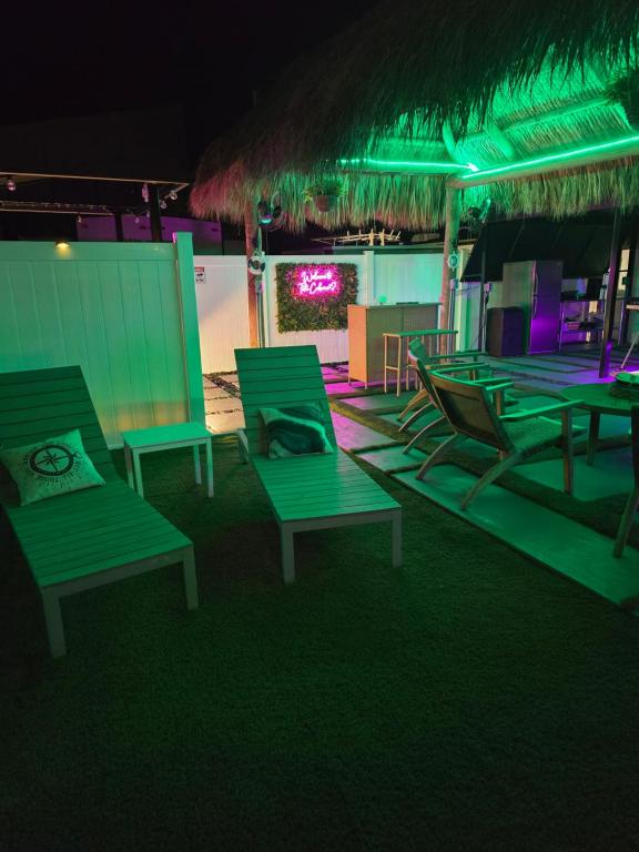 a group of green chairs on a beach at night at Tiki Cabana at Key Largo in Key Largo