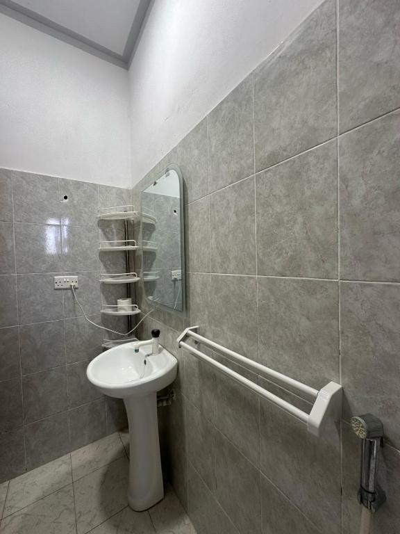 a bathroom with a sink and a mirror at Diddy & Eddy's apartment in Malindi