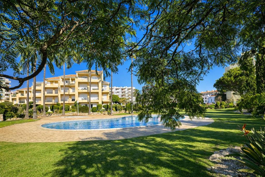 a resort with a swimming pool in a park at Ellegance - Shared Pool - 6 Guests - Vilamoura in Vilamoura