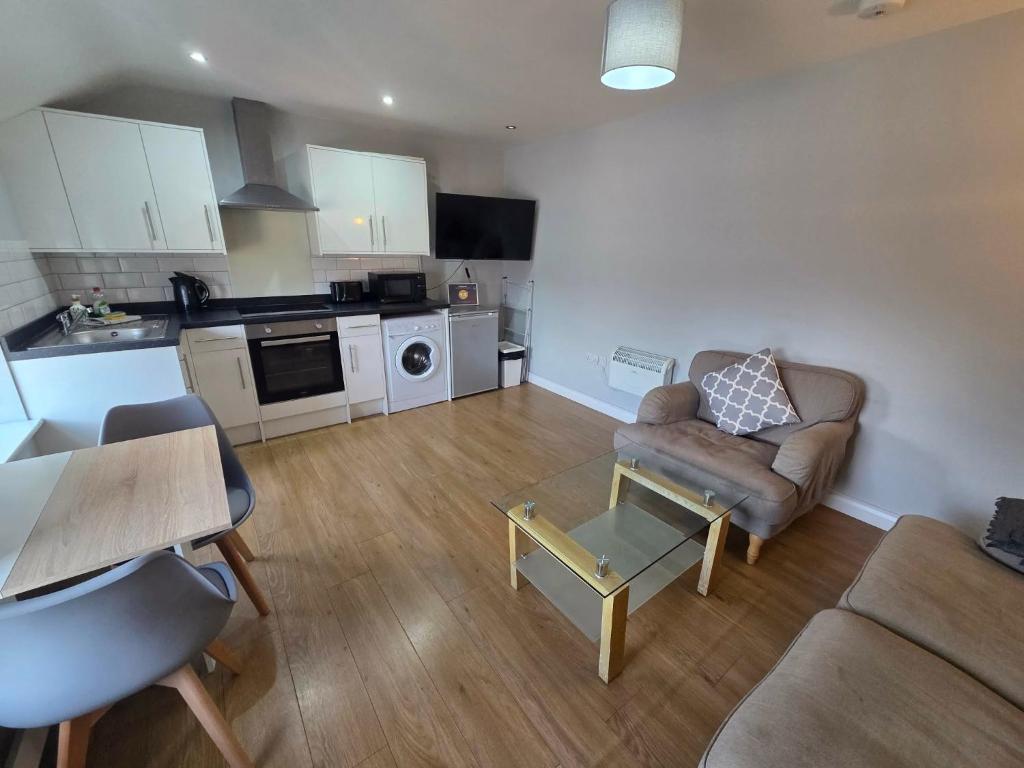 a living room with a couch and a table at 4a Smart Apartments in Newark-on-Trent