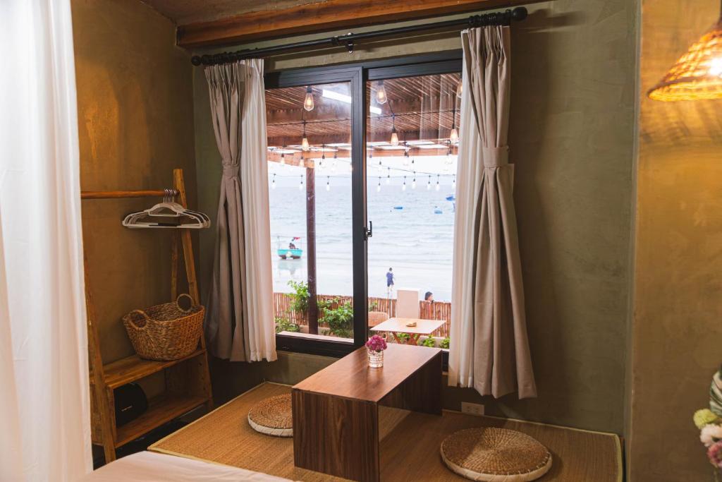 a room with a view of the beach through a window at First Love Room in Thưy Ðầm