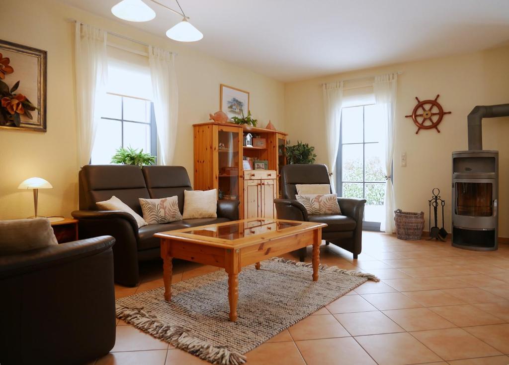 a living room with couches and a coffee table at Hagebutte in Am Schwarzen Busch