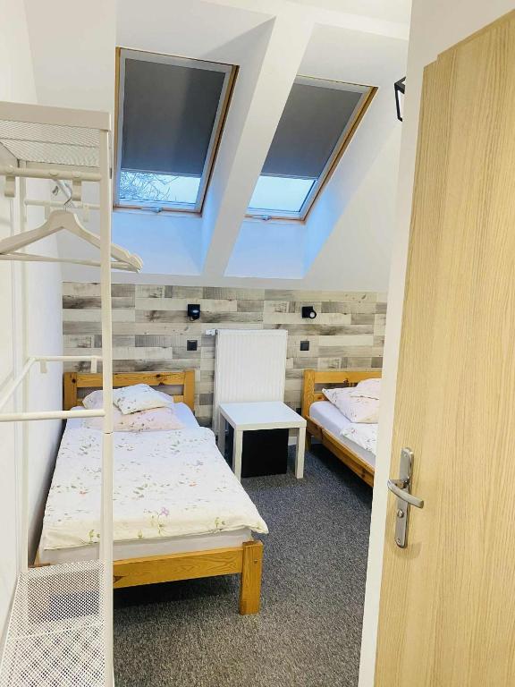 a bedroom with two bunk beds and a window at M&M Marzeniowo in Chlebowo