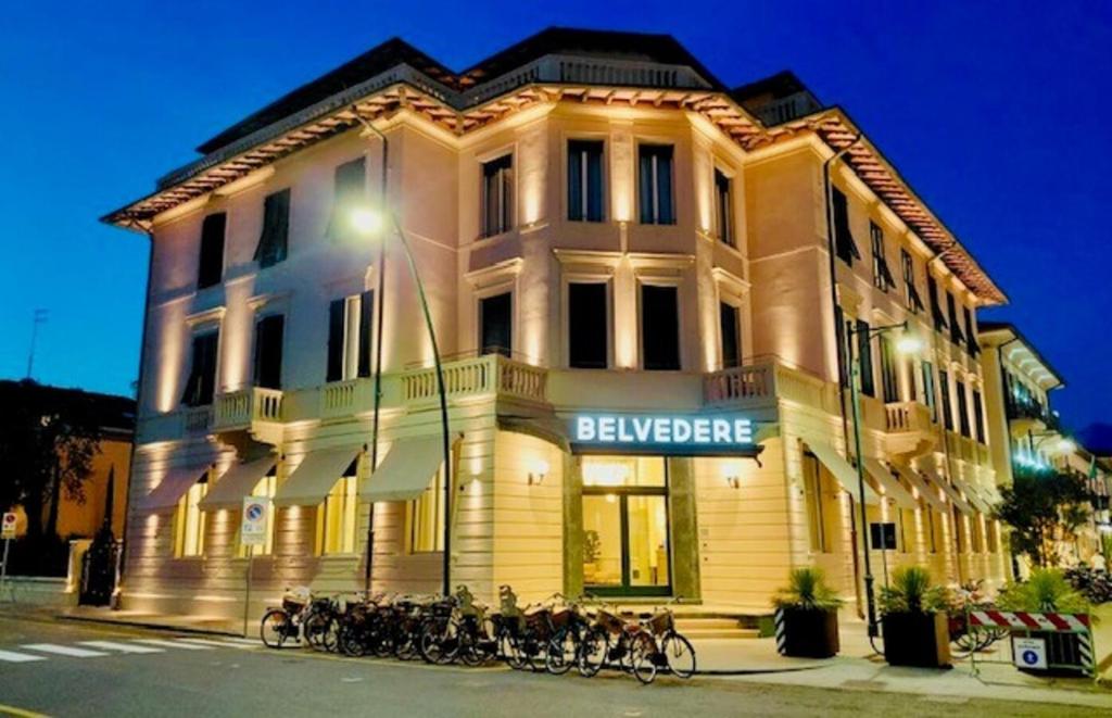 a large building with bikes parked in front of it at Hotel Belvedere in Forte dei Marmi