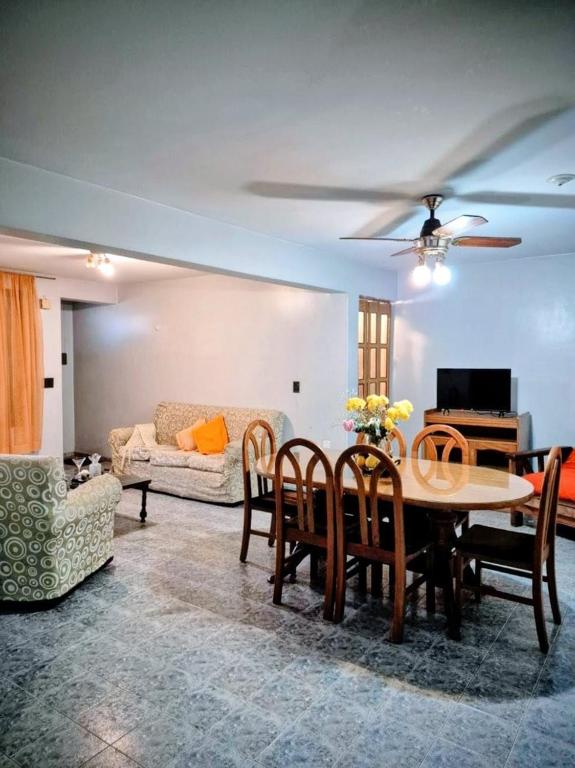a living room with a table and chairs and a couch at Casa Lola María in Mendoza