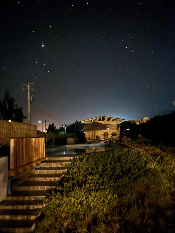 a building at night with stairs in front of it at Cabaña Camino al Valle in La Marquesa