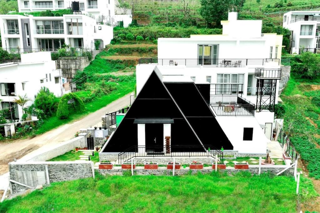 a house with a black roof on a hill at SkyGrove in Kodaikānāl