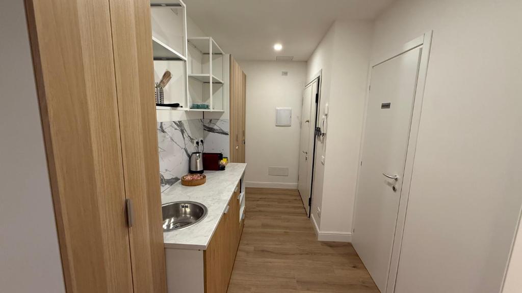 a small kitchen with a sink and a hallway at La Divina Commedia in Florence