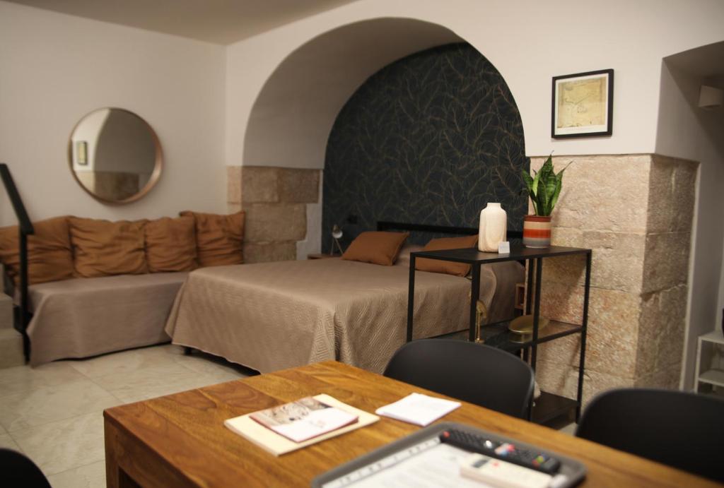 a living room with a bed and a couch at Maison De Ruelle in Barletta