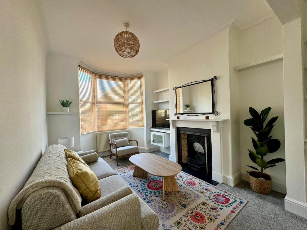 a living room with a couch and a fireplace at Stylish 2-Bed Home with Garden in Saint Thomas Station