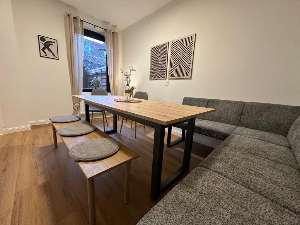 a living room with a table and a couch at ODA Living Lüneburg in Lüneburg