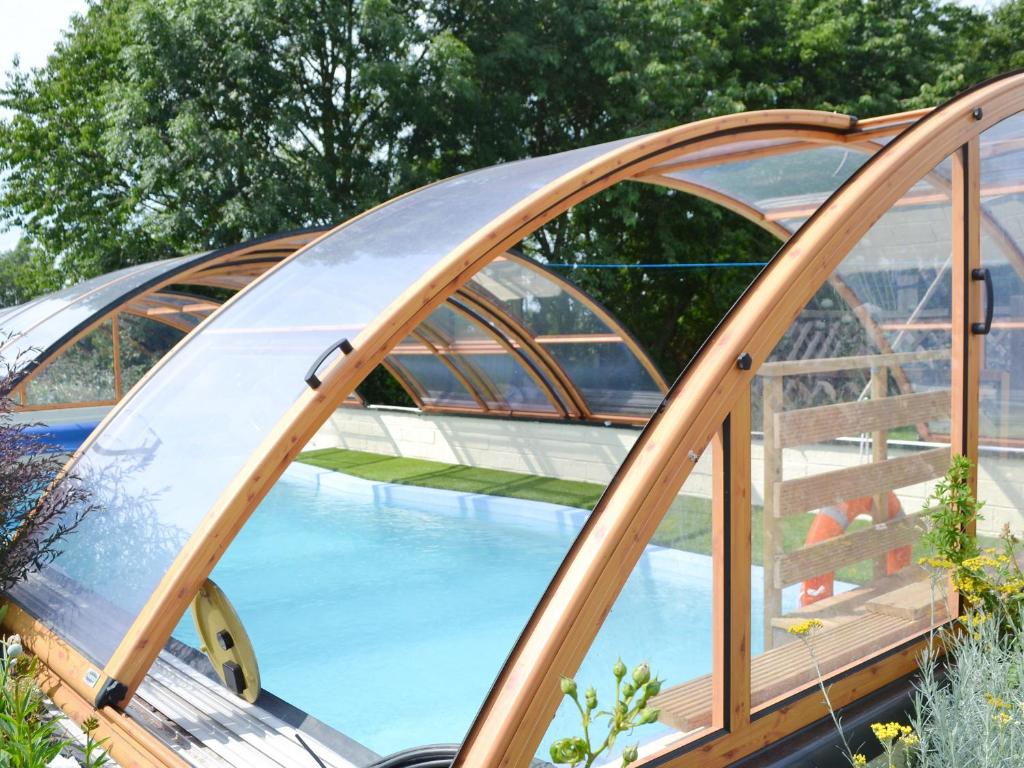 a dome greenhouse with a pool in the middle at Summertree Farm The Granary in Thornton Dale