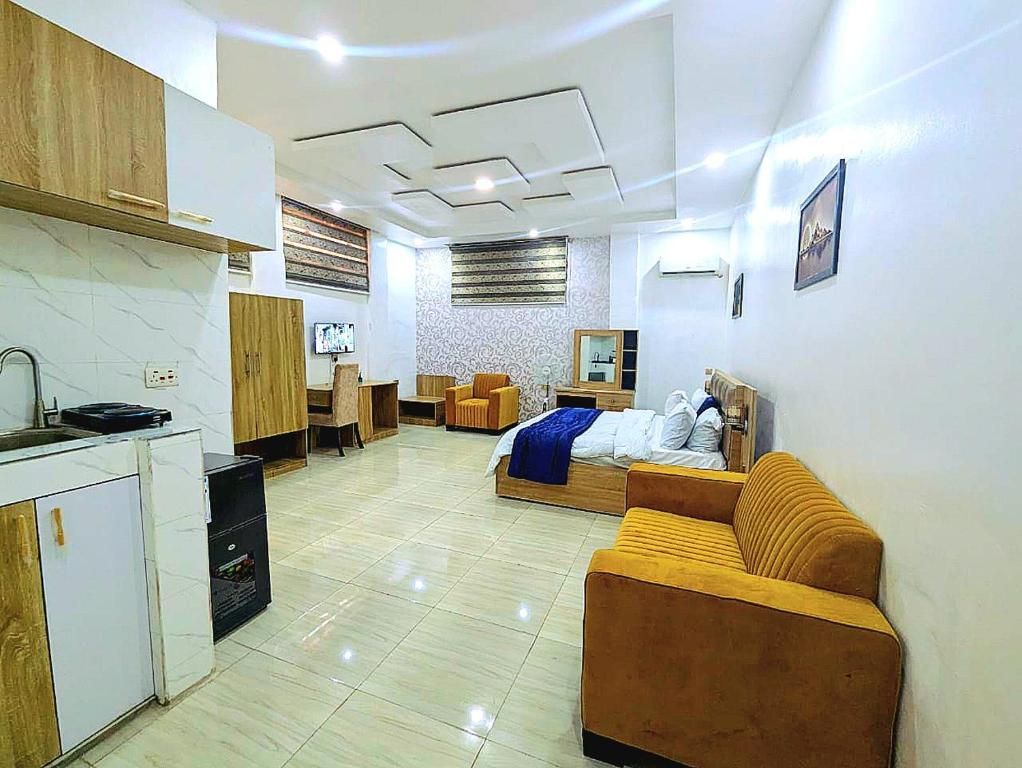 a living room with a couch and a bed at Frenezia Hotel and Apartment Ikeja GRA in Ikeja