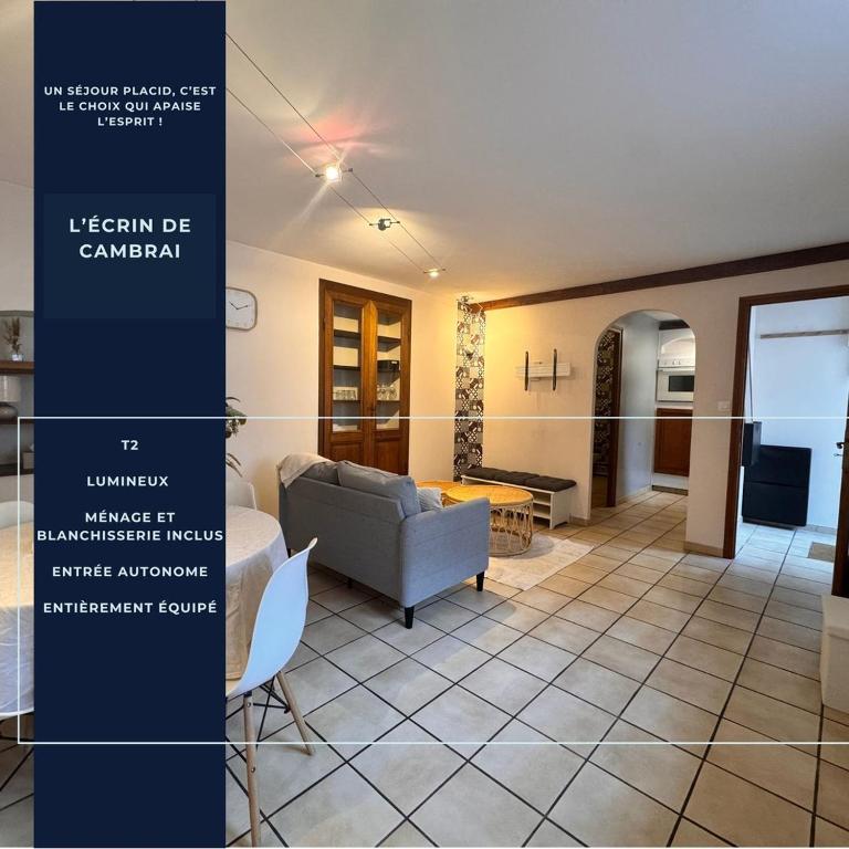 a living room with a couch and a table at L'écrin de Cambrai - Appt 40 m² centre Cambrai in Cambrai