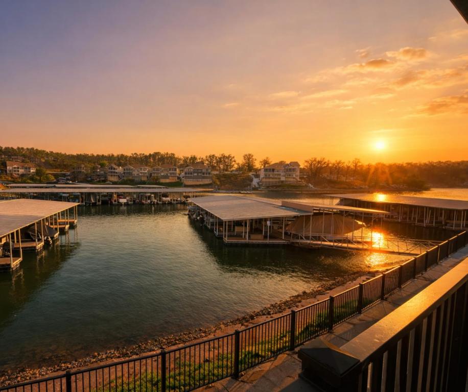 a sunset over a body of water with docks at Blueys Lakefront 2 Bed and 2 Bath Condo in Abbeyville