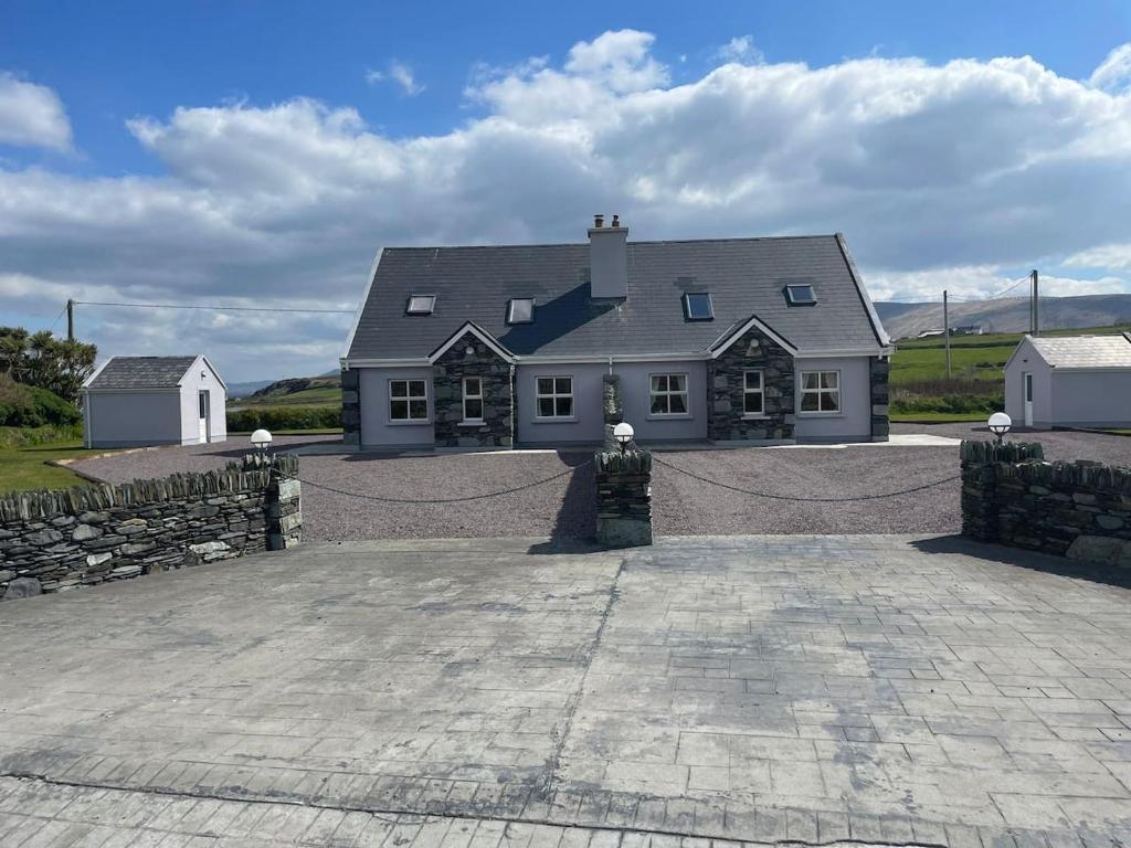 a large white house with a statue in front of it at Bray Head View 2 in Clynacartan