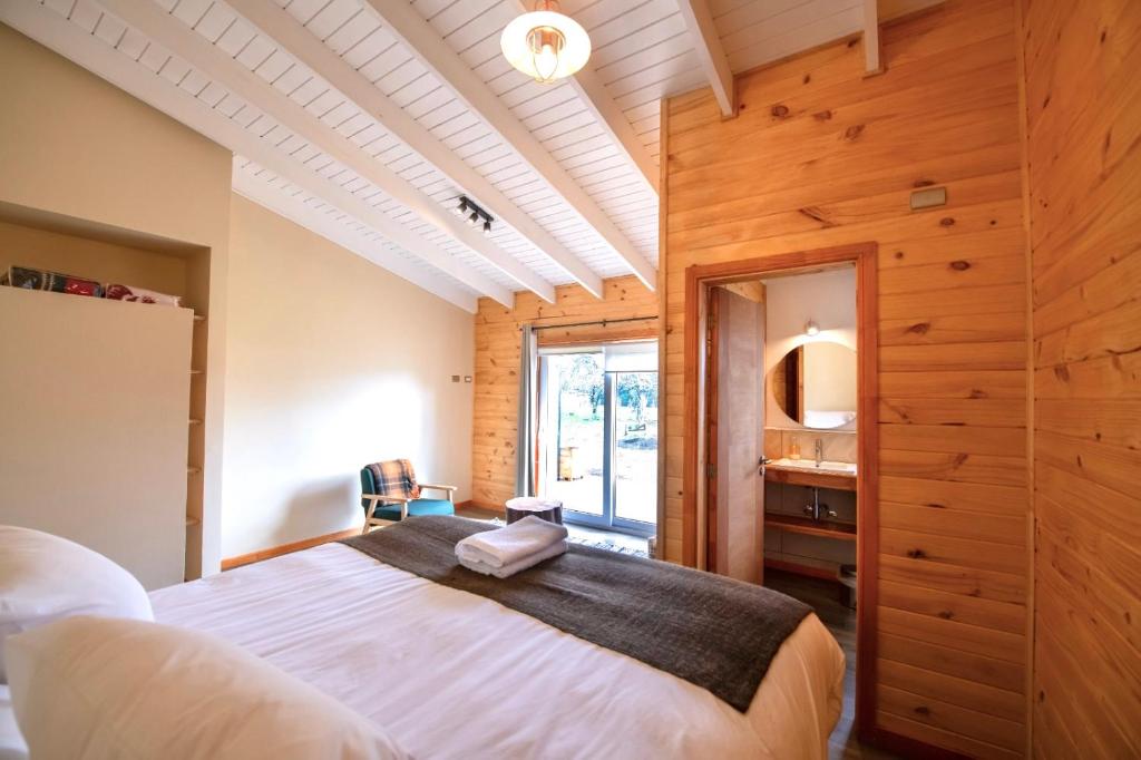 a bedroom with a large bed and a window at Vuelta al Sur in Puelo