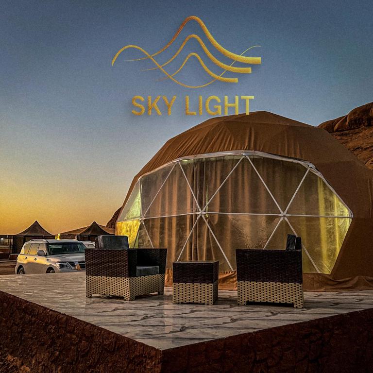 a large dome tent with chairs in front of it at Skylight Wadi Rum Camp in Disah