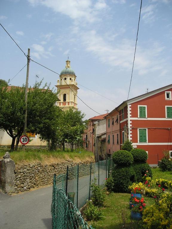 a building with a clock tower in the distance at Casetta Rosa in Pignone