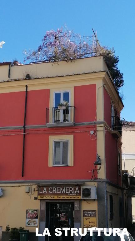a red and yellow building on a city street at casaNARDIELLO in Capua