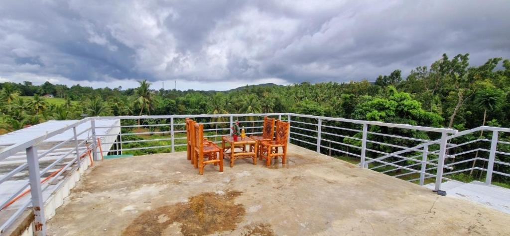 two chairs and a table on top of a house at Wengsmont in Tubod