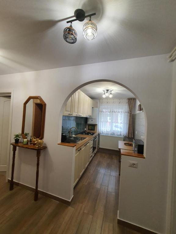 a kitchen with an archway in the middle of a room at BicazApart in Bicaz