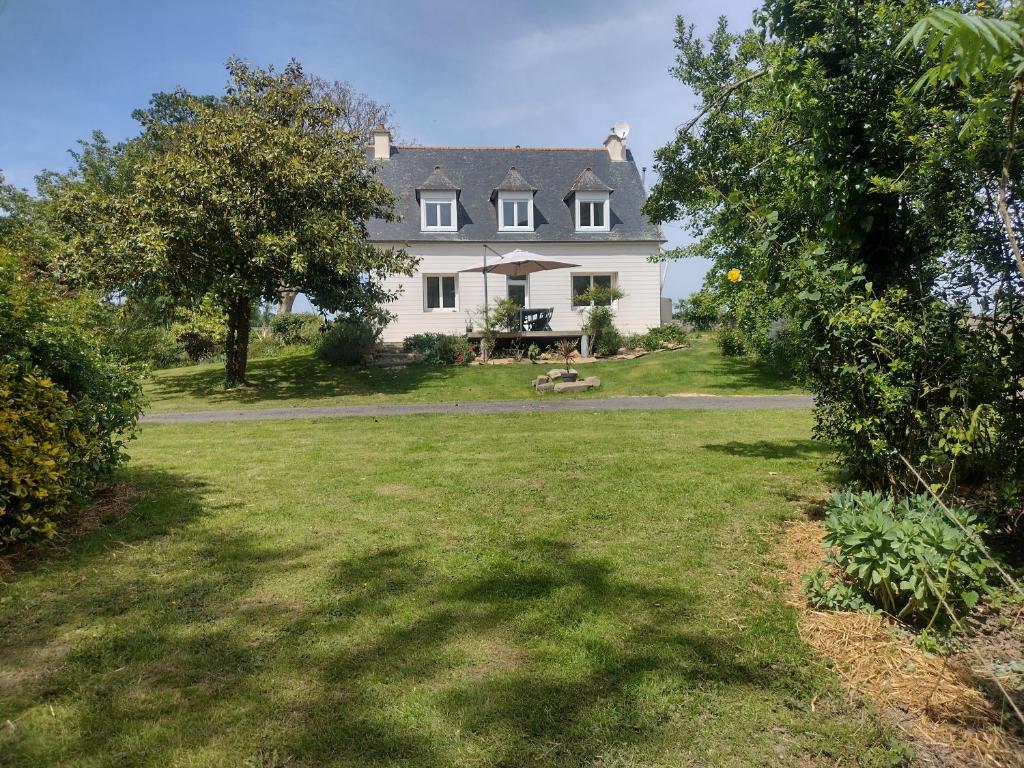 a large white house with a large yard at Gite des Noës in Lamballe Armor