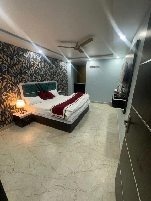 a bedroom with a bed and a tv in it at Hotel KS GRAND in Mandhana