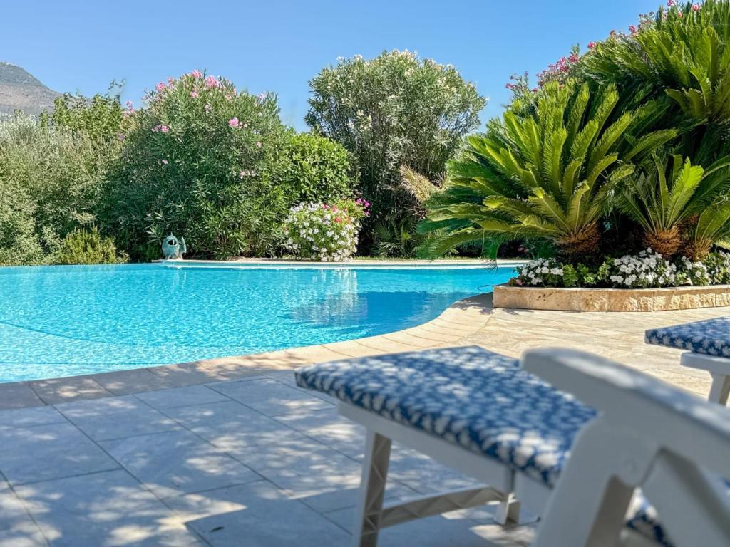a swimming pool with two lawn chairs and a swimming pool at Gite Mireille in Carros