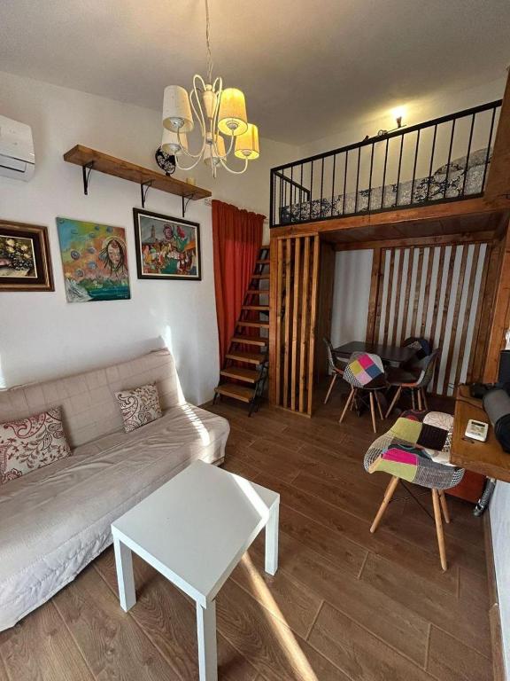 a living room with a couch and a staircase at Sweet home with a jard Slavica in Šušanj