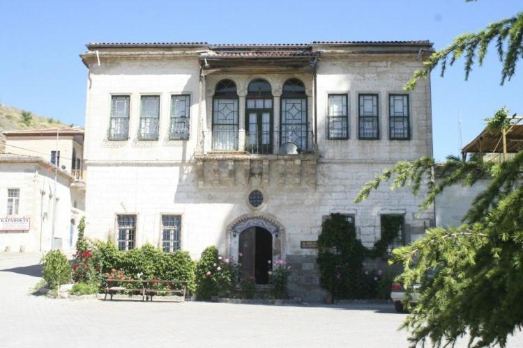 a large white building with a balcony on top of it at Old Greek House in Urgup