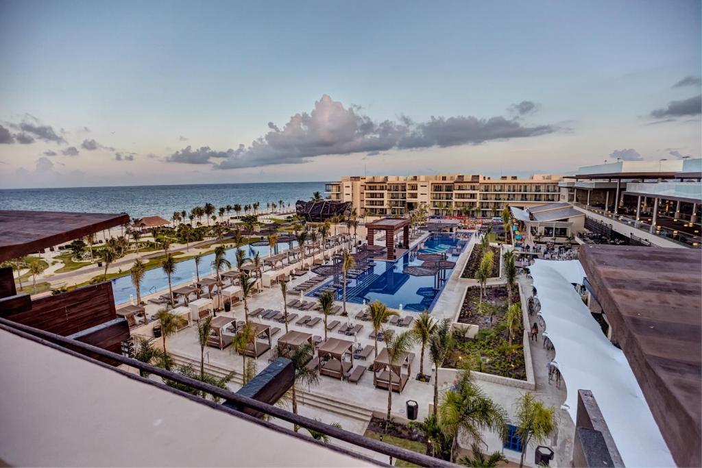an aerial view of a resort with a pool and the ocean at Royalton Riviera Cancun, An Autograph Collection All-Inclusive Resort & Casino in Puerto Morelos
