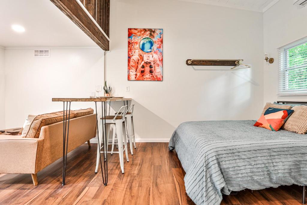 a bedroom with a bed and a desk and a table at The Moon Loft in Atlanta