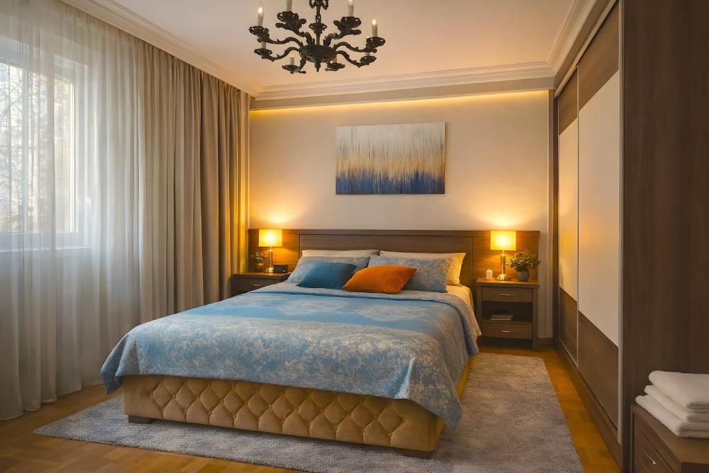 a bedroom with a bed and a chandelier at Central Park Apartment in Čačak