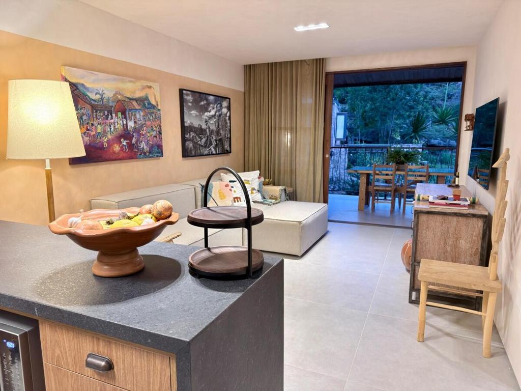 a living room with a couch and a table at Diamantino Residence - Barro in Mucugê