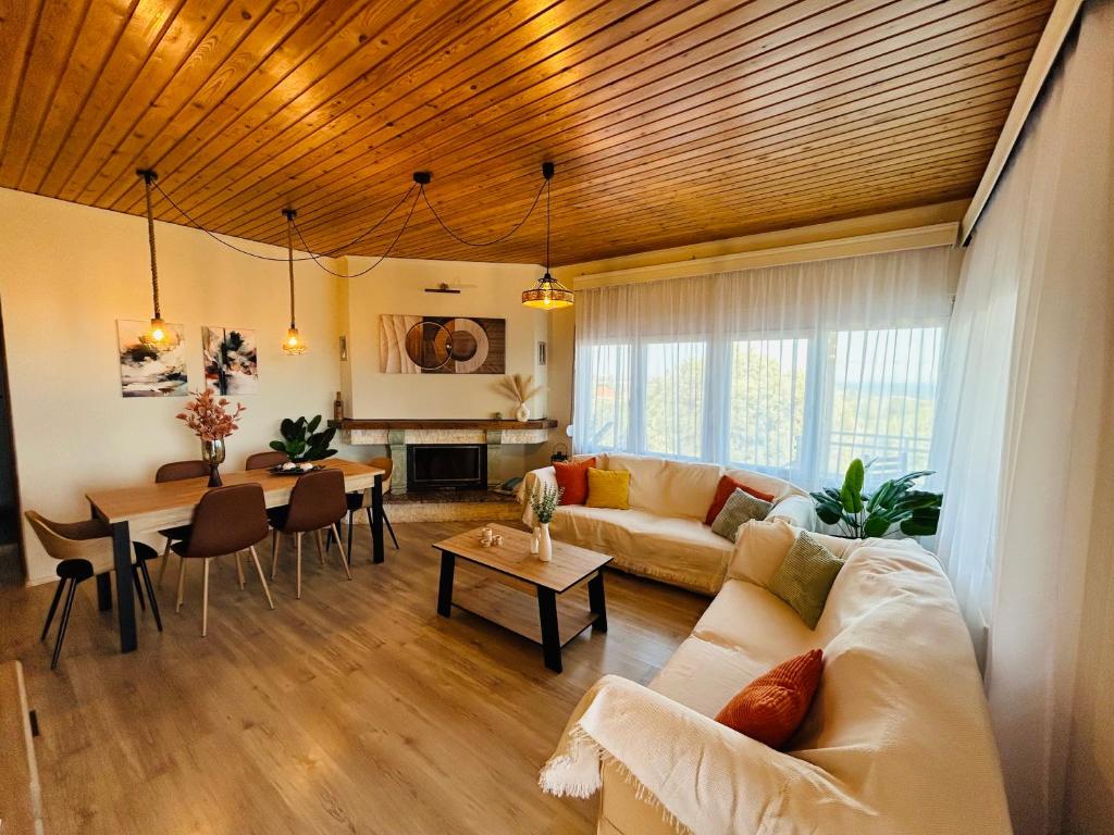 a living room with a couch and a table at Elaia Horizon Makri in Alexandroupoli