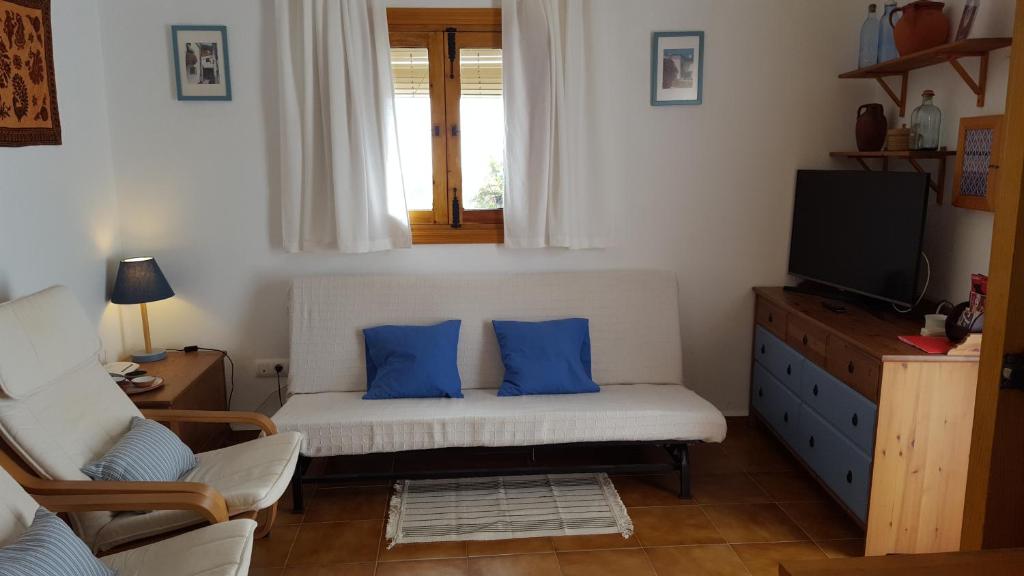 a living room with a couch with blue pillows at Holiday home La Atalaya de Vejer in Vejer de la Frontera