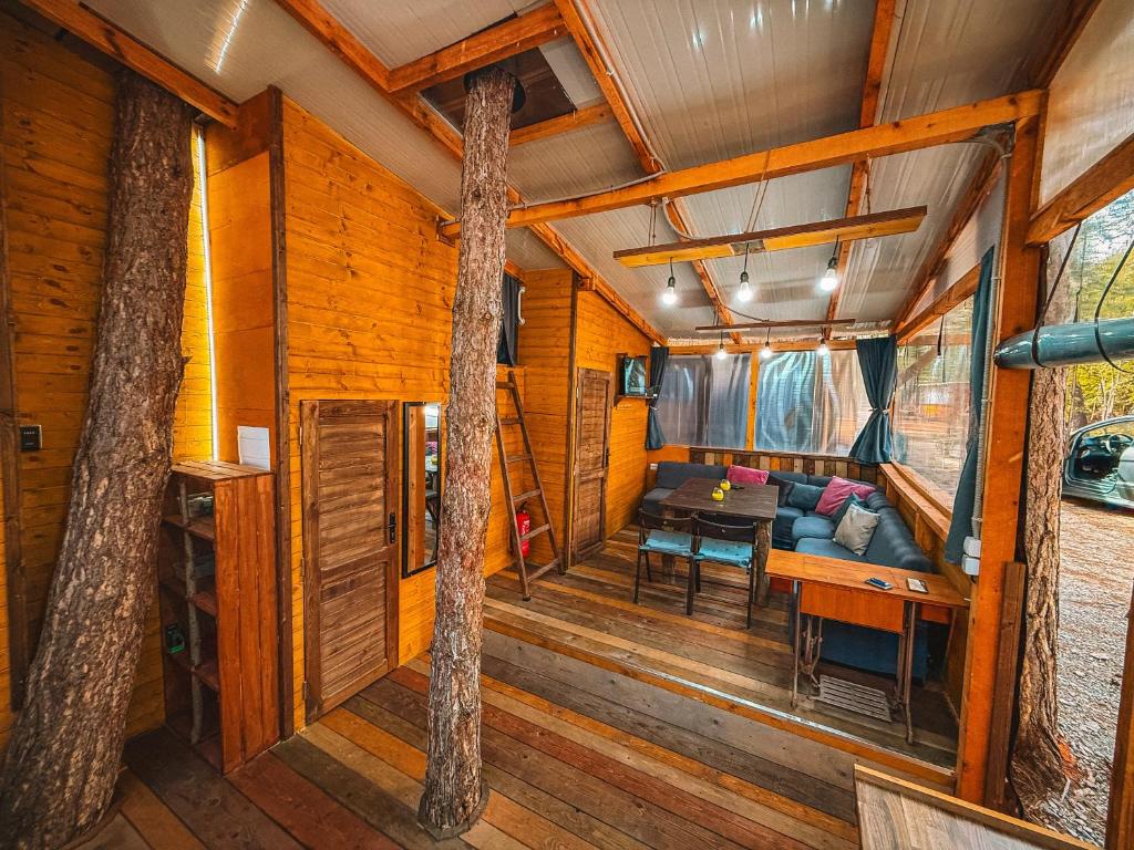 a living room and dining room in a tree house at Бунгало Борче in Burgas