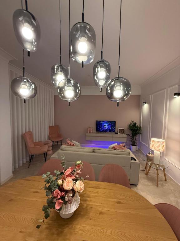 a living room with a table and a couch and lights at Odivelas Place 1 in Odivelas