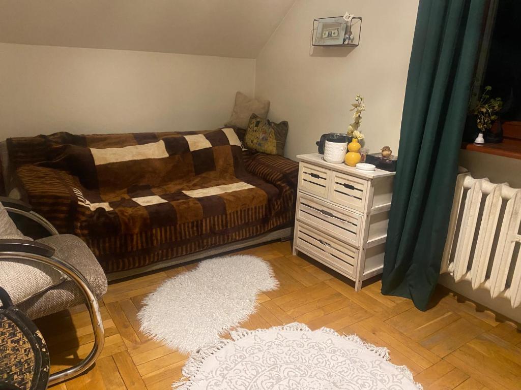 a living room with a couch and a table at Chromiczówka in Chojna