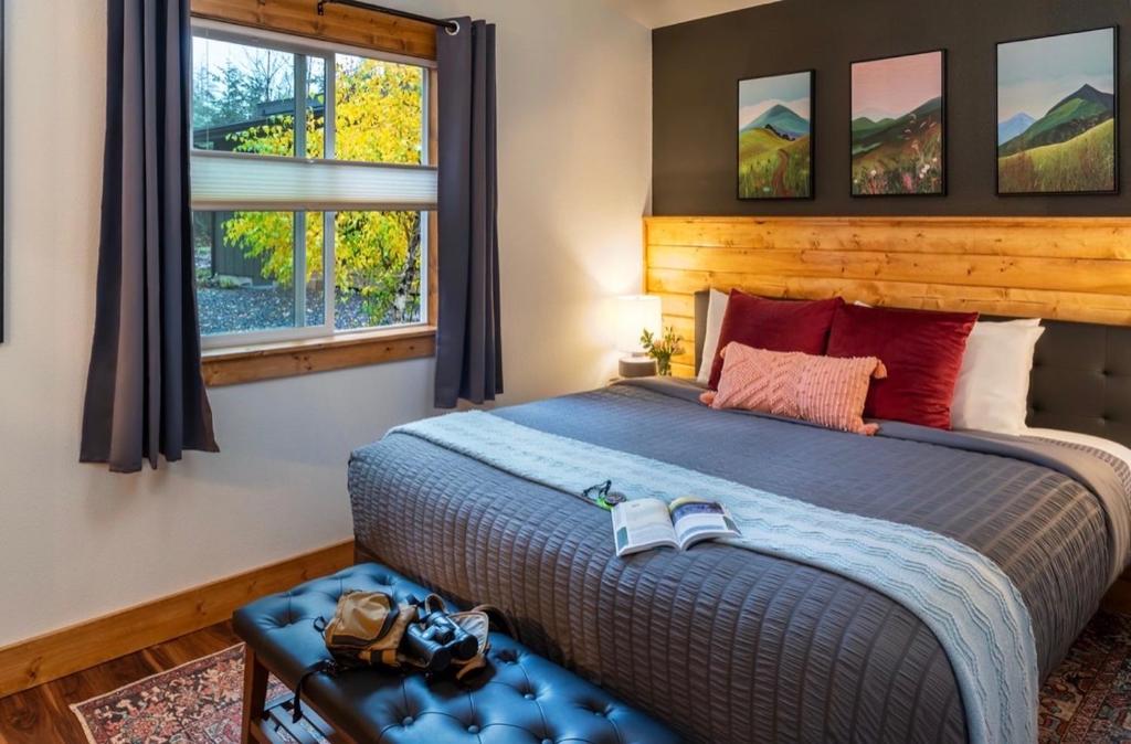 a bedroom with a large bed and a window at Backwoods Cabins in Carson
