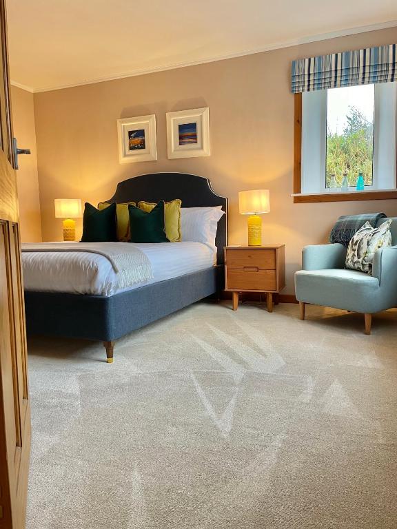 a bedroom with a bed and a blue chair at Pabbay House in Back