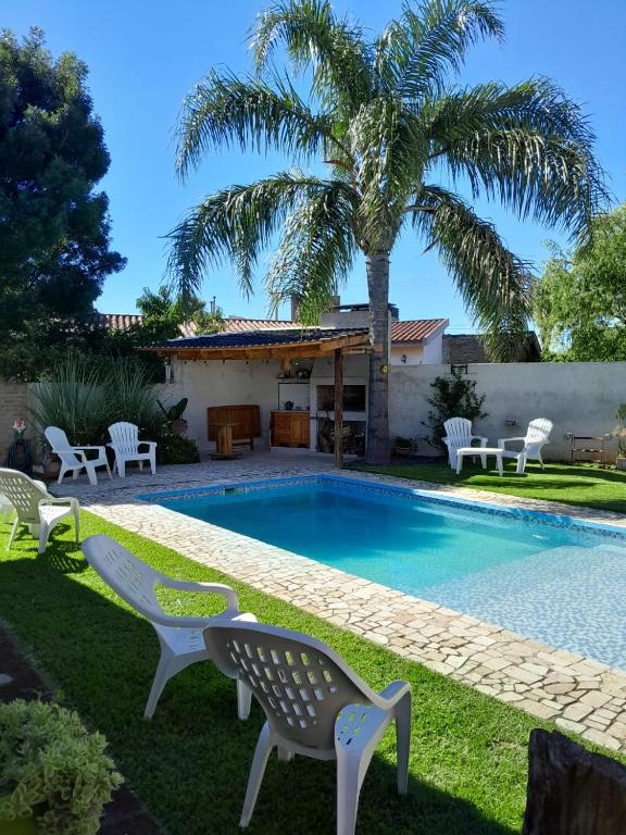 a villa with a swimming pool and a palm tree at Pura Brisa in Almafuerte