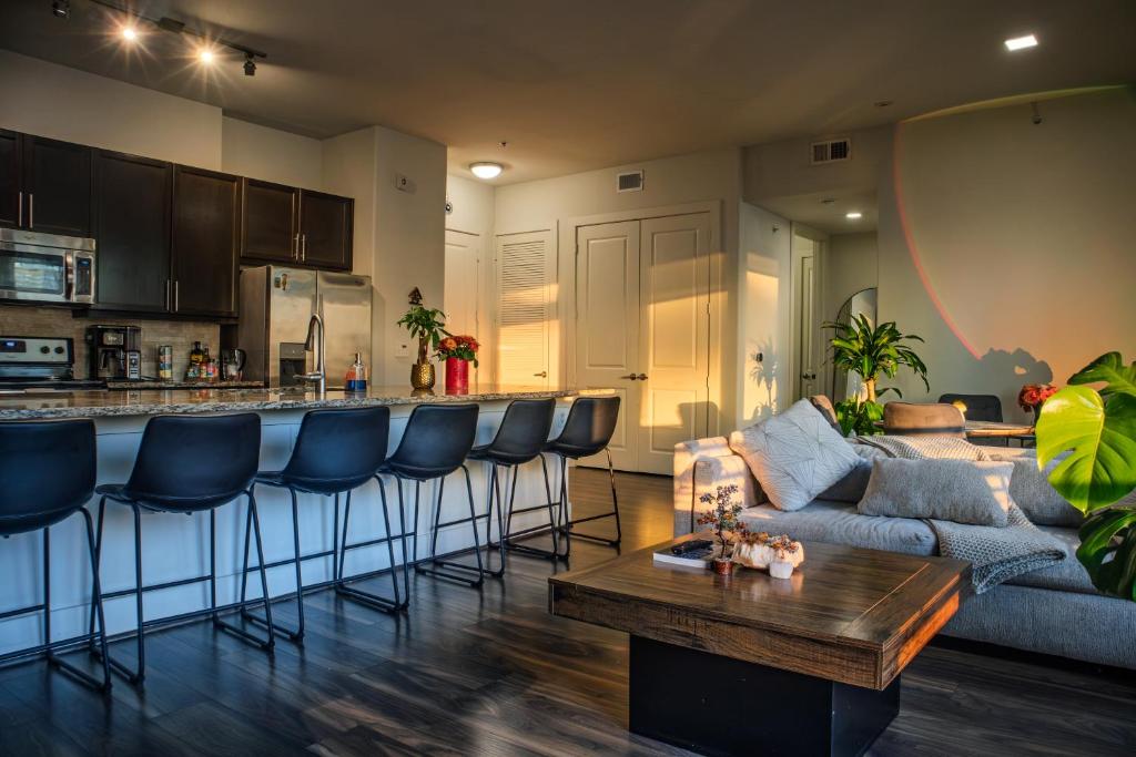 a living room and kitchen with a couch and a table at Downtown views by the Lake in Austin
