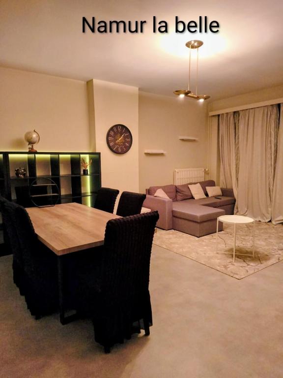 a living room with a table and a couch at Namur cozy apartment in Namur