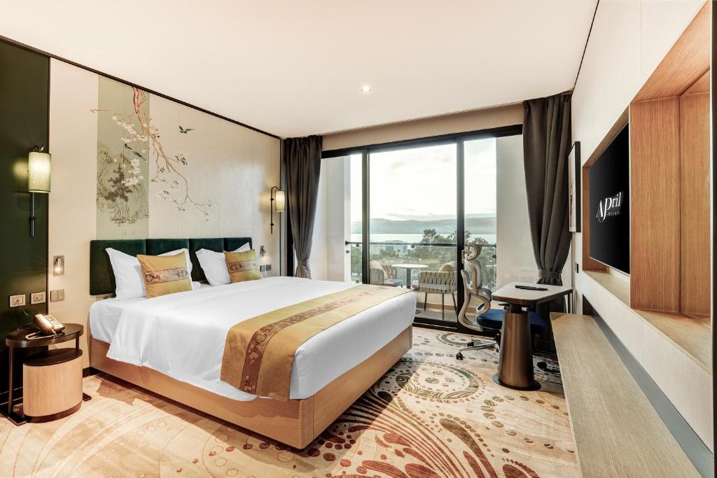 a hotel room with a bed and a balcony at April Hotel in Aqaba