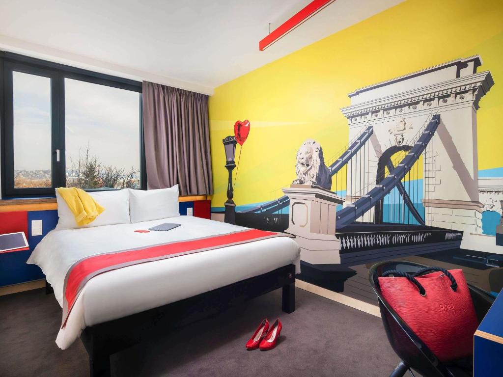 a hotel room with a bed and a bridge at ibis Styles Budapest Citywest in Budapest