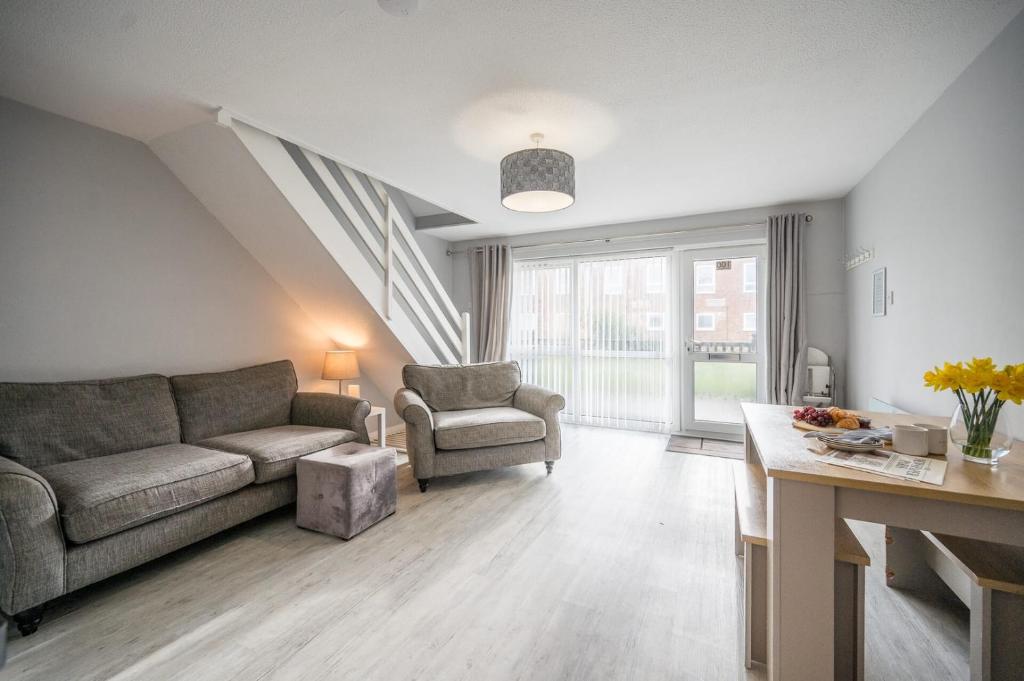 a living room with a couch and a chair at 100 Waterside Park in Corton