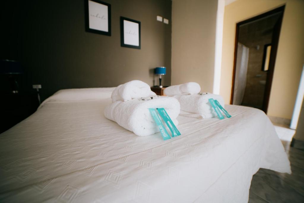 a white bed with towels on top of it at Río Hotel in Colorado River